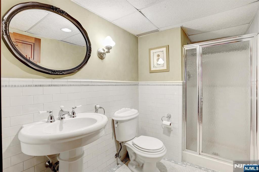 4 Summertree Way Montvale, NJ 07645 - Photo 34 of 50 a bathroom with a sink a mirror and a toilet
