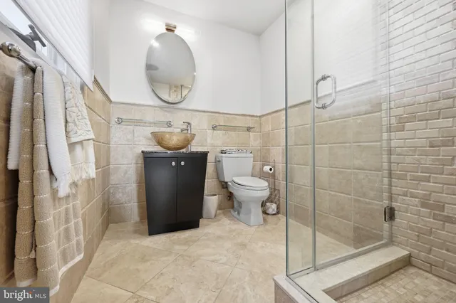 a bedroom with a bed and painting on the wall