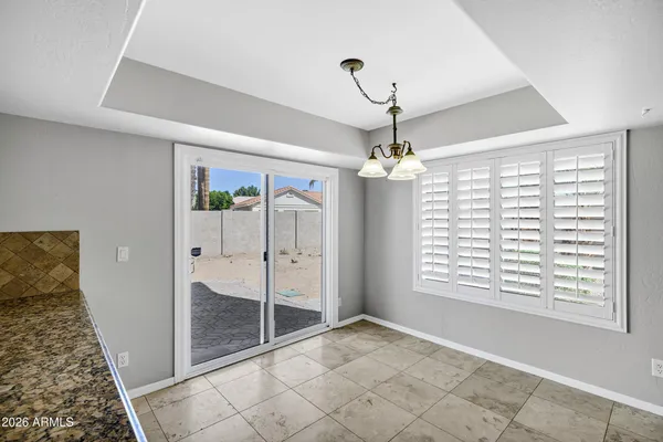 a view of a livingroom with a ceiling fan and hardwood floor