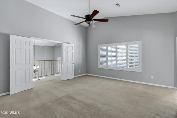 a view of a house with a yard and large tree