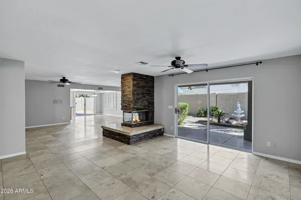 a view of a livingroom with a ceiling fan and window