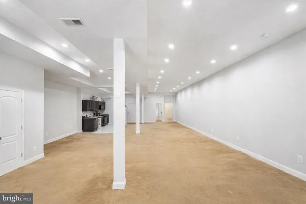 a view of kitchen with kitchen island and stainless steel appliances