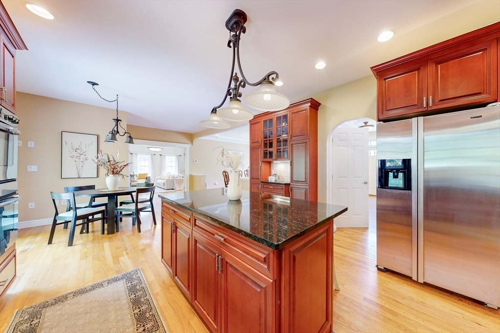 99 Ridge Street Winchester, MA 01890 - Photo 12 of 40 a kitchen with stainless steel appliances granite countertop sink stove top oven and cabinets