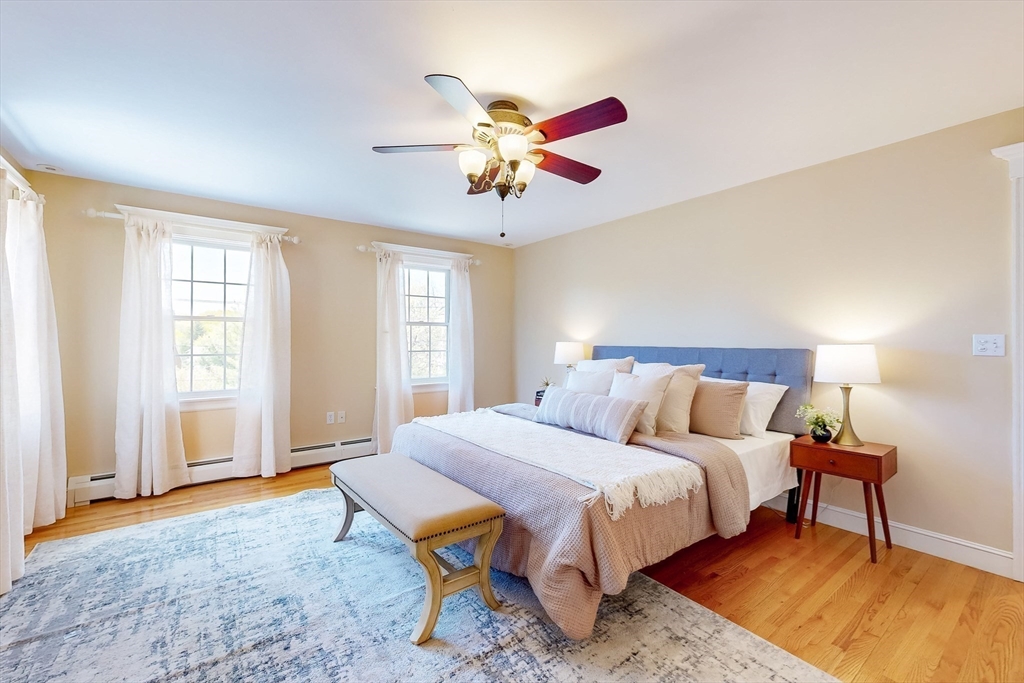 99 Ridge Street Winchester, MA 01890 - Photo 19 of 40 a bedroom with a bed and a chandelier