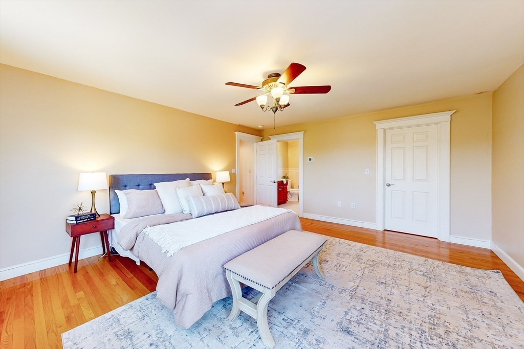 99 Ridge Street Winchester, MA 01890 - Photo 20 of 40 a bedroom with a bed and a chandelier