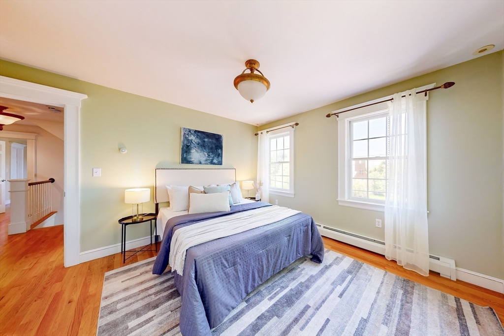 99 Ridge Street Winchester, MA 01890 - Photo 23 of 40 a bedroom with a bed and wooden floor