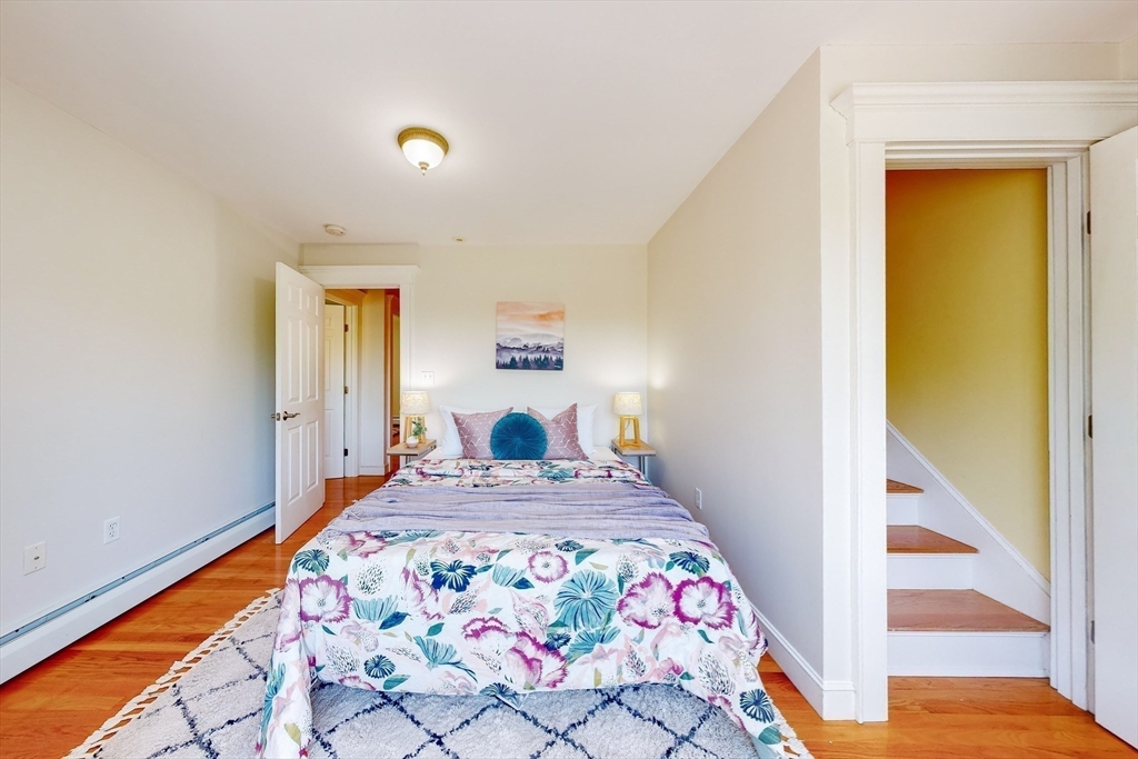 99 Ridge Street Winchester, MA 01890 - Photo 26 of 40 a bedroom with a bed and a table in it