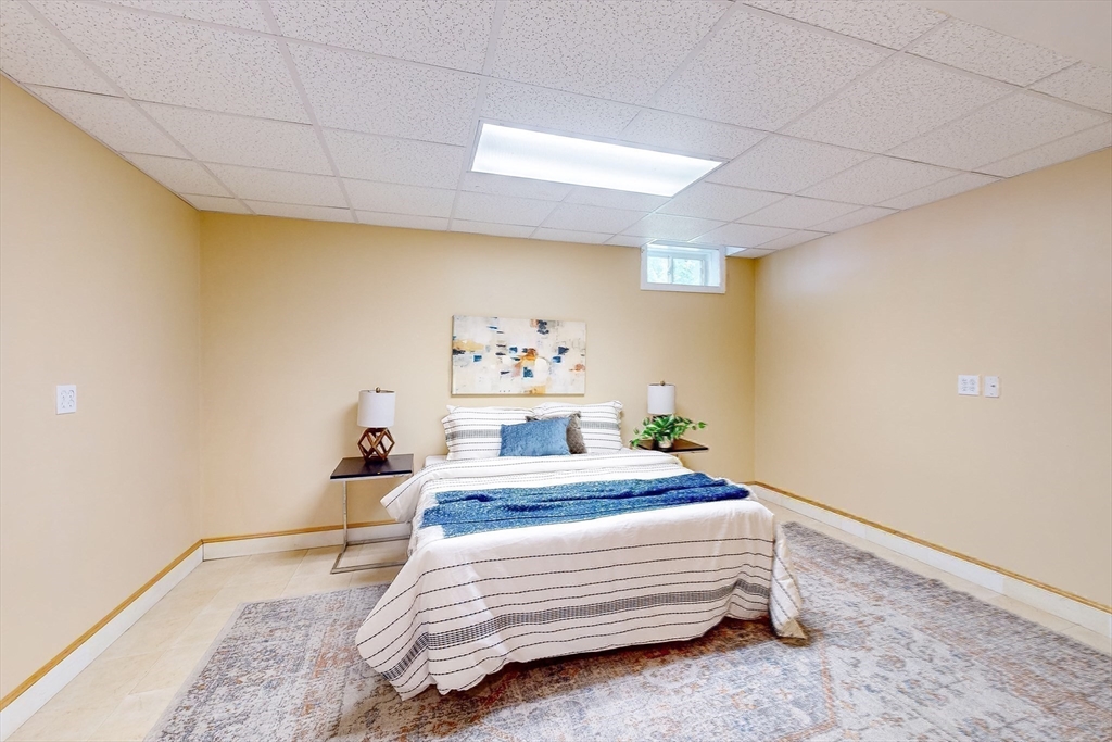 99 Ridge Street Winchester, MA 01890 - Photo 31 of 40 a bedroom with a bed and a dresser