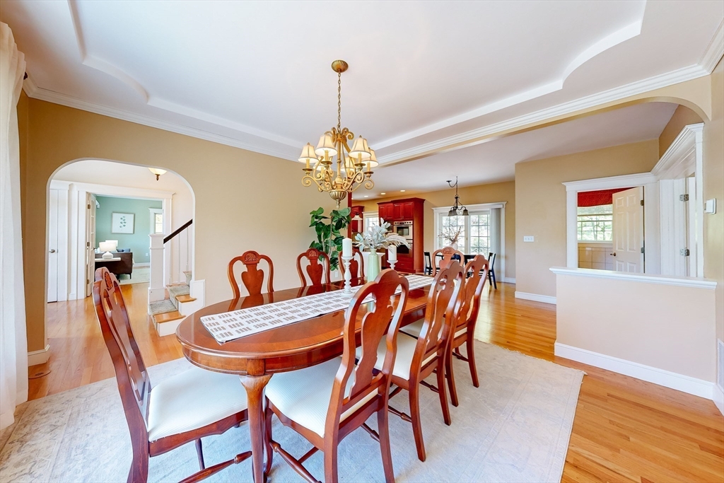 99 Ridge Street Winchester, MA 01890 - Photo 5 of 40 a dining room with furniture a chandelier and wooden floor