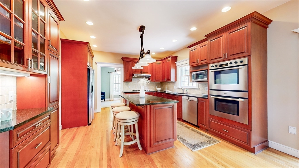 99 Ridge Street Winchester, MA 01890 - Photo 10 of 40 a kitchen with stainless steel appliances granite countertop a stove a sink and a refrigerator