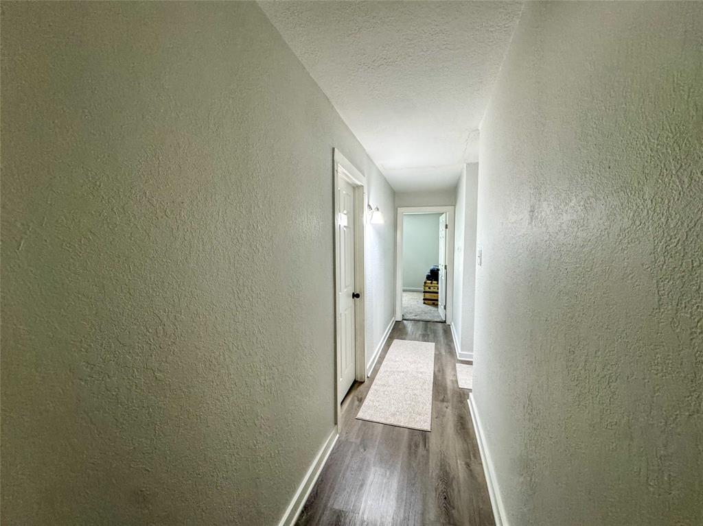 3206 Mitchell Street Greenville, TX 75402 - Photo 14 of 24 a view of a hallway with wooden floor