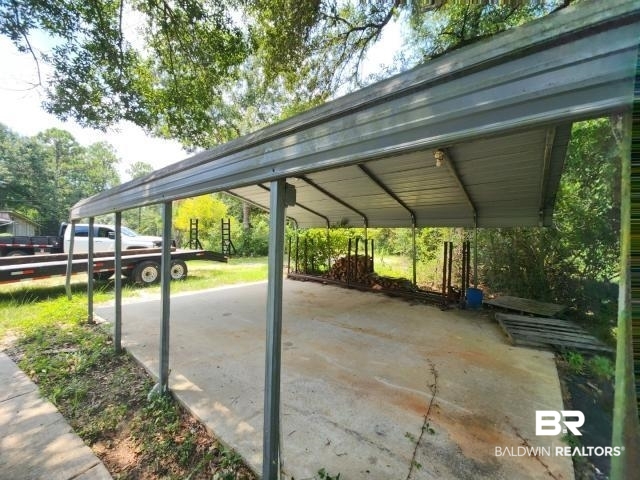 32749 Antietam Road Lillian, AL 36549 - Photo 46 of 47 View of parking / parking lot featuring a carport