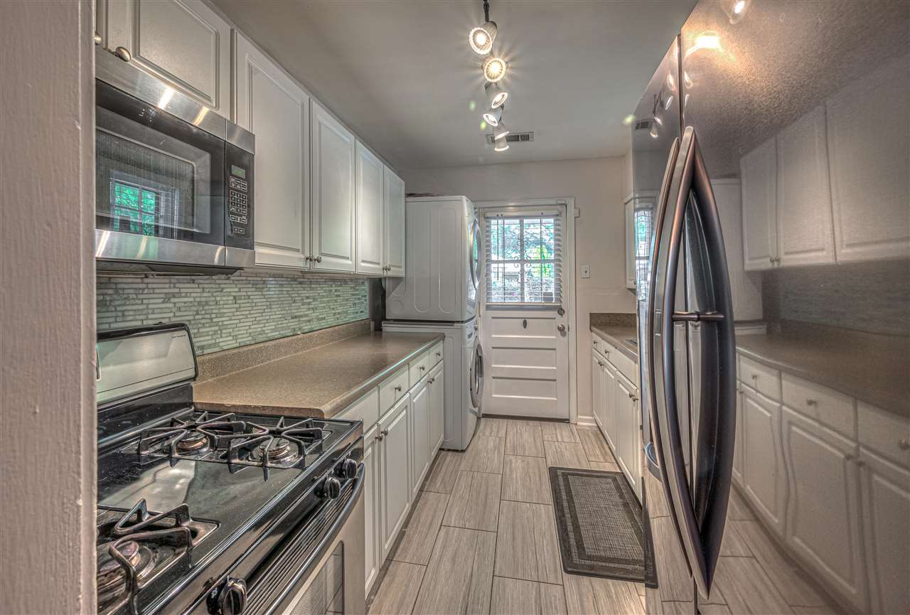 4680 Flamingo Road Memphis, TN 38117 - Photo 9 of 23 a kitchen with granite countertop a stove and a refrigerator