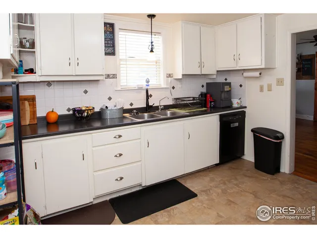 a kitchen with stainless steel appliances granite countertop a sink a stove and white cabinets