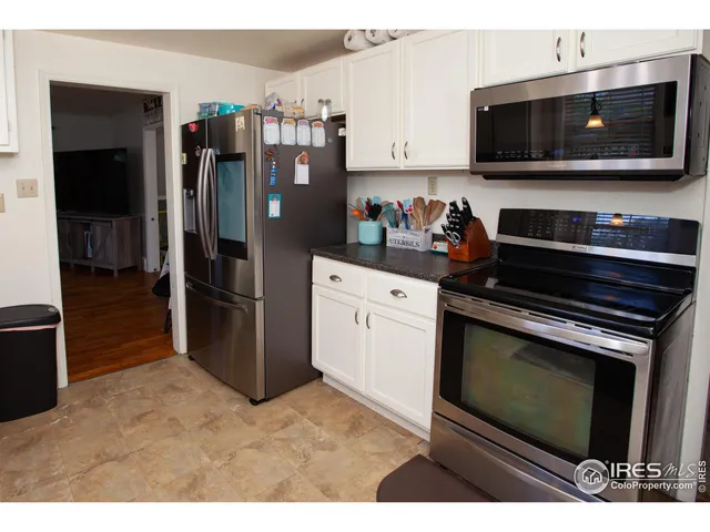 a kitchen with stainless steel appliances a stove a microwave and a refrigerator