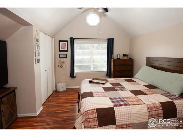 a bedroom with a bed window and a table