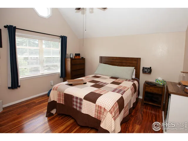 a bedroom with a bed a dresser and book shelf