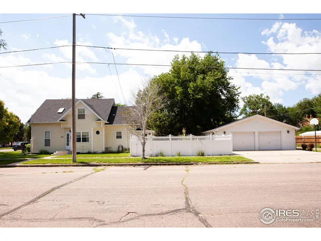 a house with a yard and a large parking space