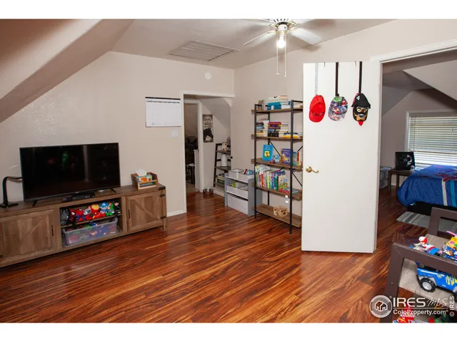 a view of a workspace with furniture and wooden floor