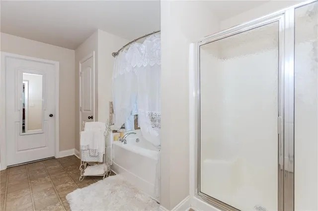 a bathroom with a bathtub and a shower