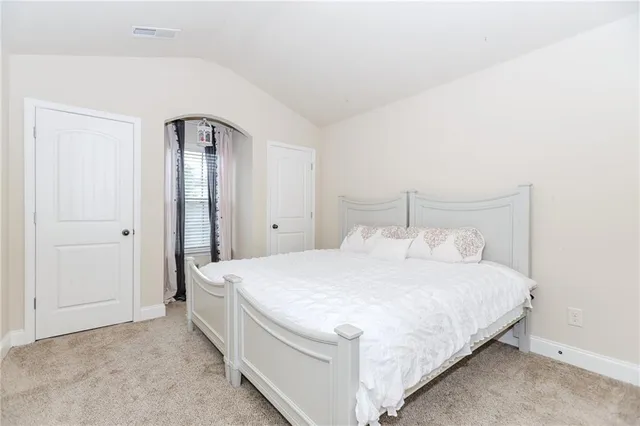 a bedroom with a bed and a mirror