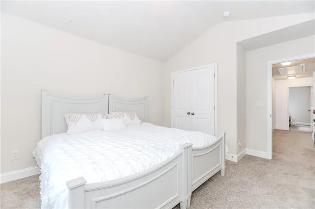 a large white bed in a white room