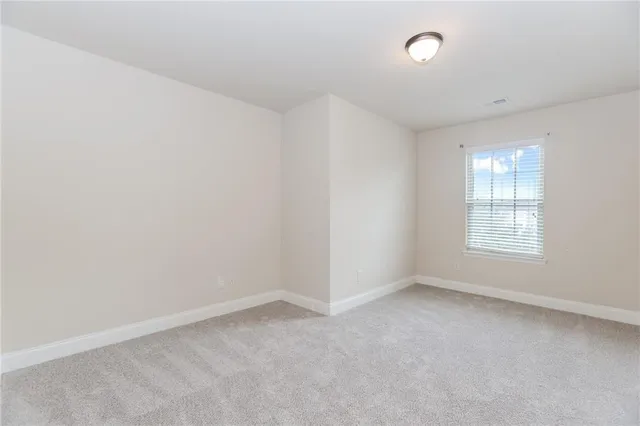 an empty room with a empty space and windows