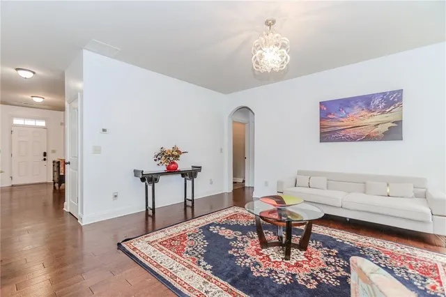 a living room with furniture a table and wooden floor