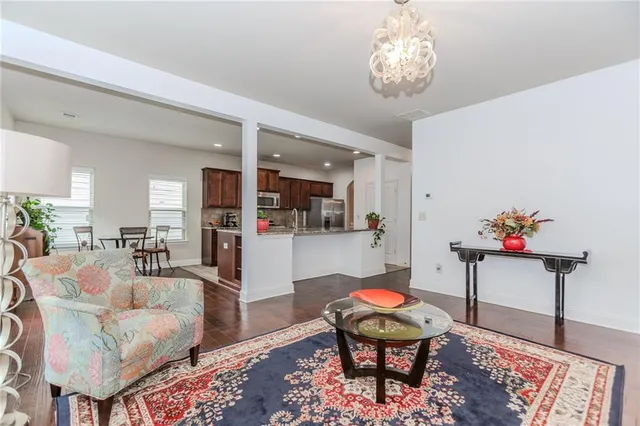 a living room with furniture and a chandelier