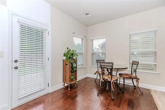 a dining room with furniture and wooden floor