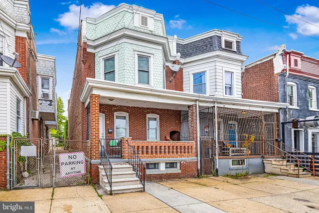 a view of a brick house with large windows