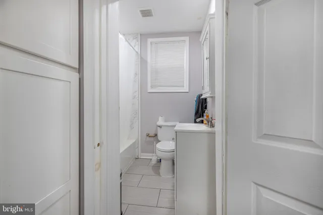 a bathroom with a sink toilet and vanity