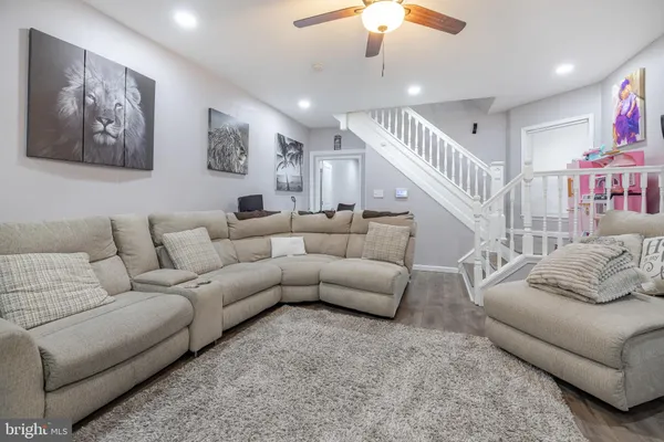 a very nice looking living room with a large window and potted plants