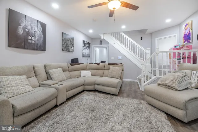 a very nice looking living room with a large window and potted plants