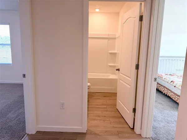 a kitchen with stainless steel appliances kitchen island granite countertop a refrigerator sink and white cabinets