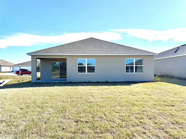 a house view with swimming pool in front of it