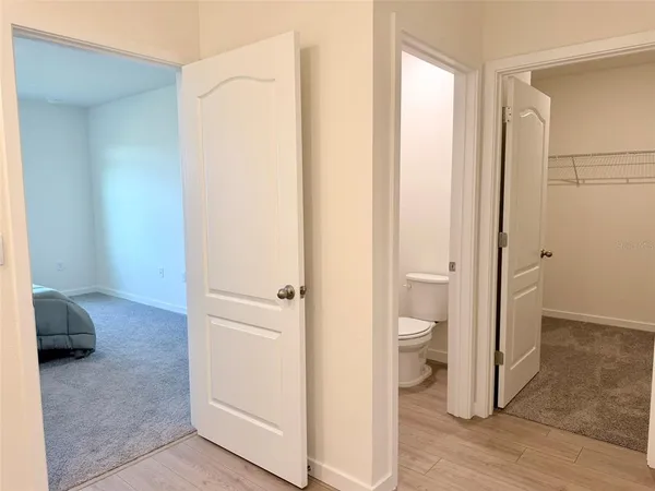a bathroom with a granite countertop sink toilet a mirror and bathtub