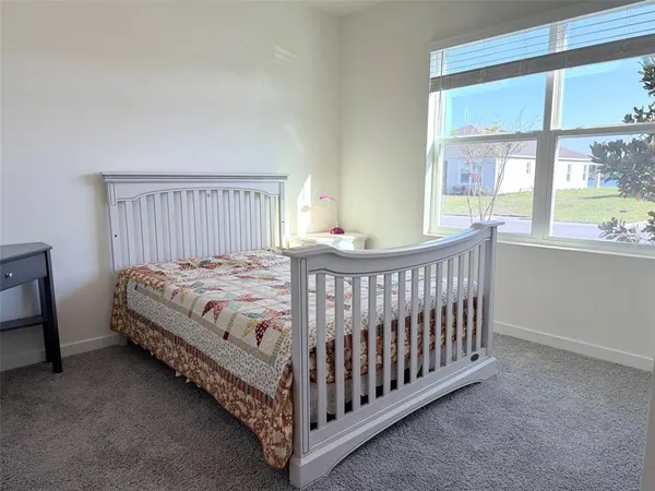 a large kitchen with stainless steel appliances a sink a stove top oven a counter space and cabinets