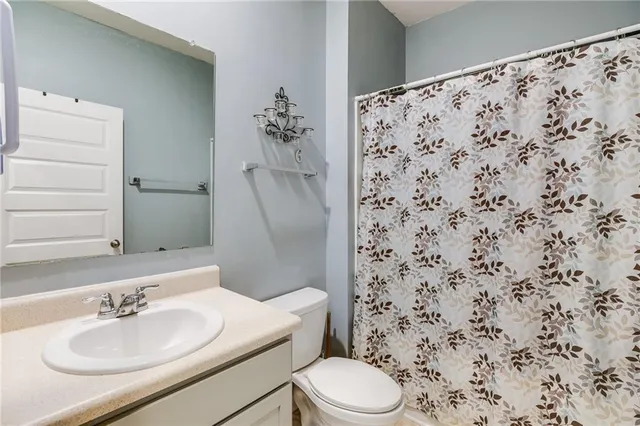 a bathroom with a sink toilet and mirror