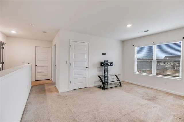 a view of a room with gym equipment and a large window