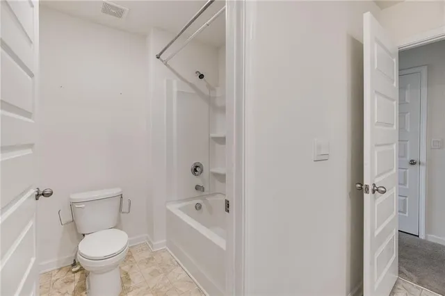 a bathroom with a bathtub and a toilet