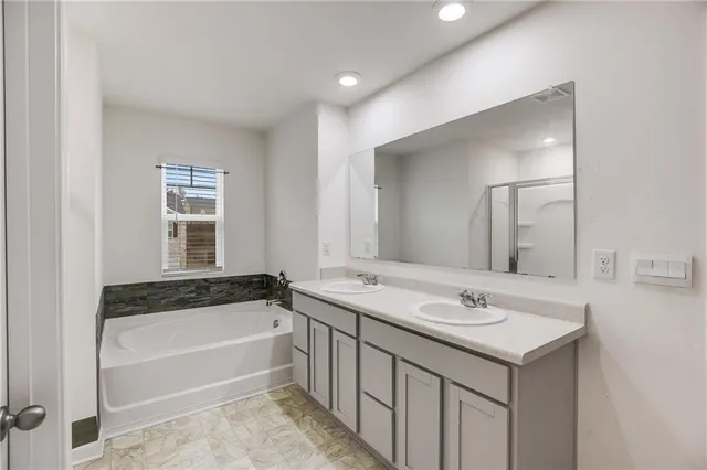 a bathroom with a bathtub a sink and a window