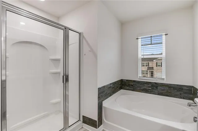 a bathroom with a bathtub and a shower