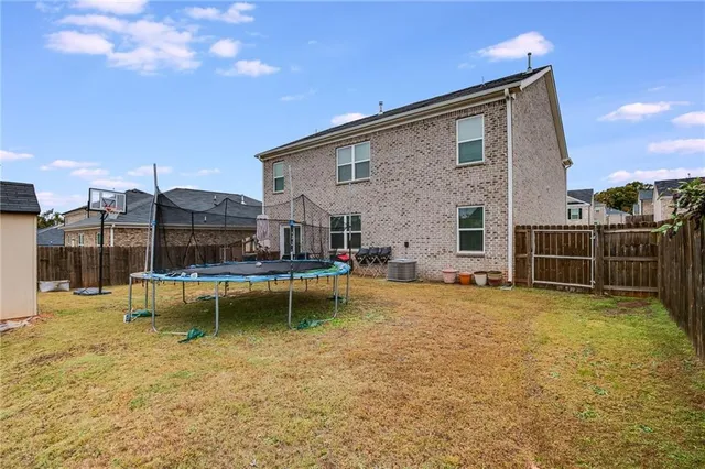 a view of a house with pool porch and chairs