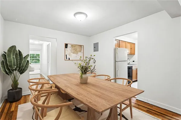 a view of a dining room with furniture and wooden floor