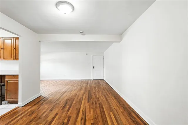 a view of a room with wooden floor