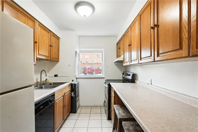 a kitchen that has a sink and a stove in it
