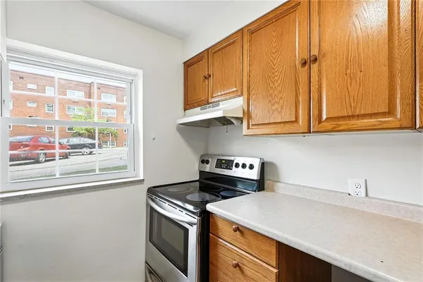 a kitchen with stainless steel appliances granite countertop a sink a stove and a microwave