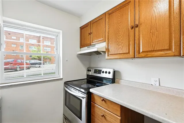 a kitchen with stainless steel appliances granite countertop a sink a stove and a microwave