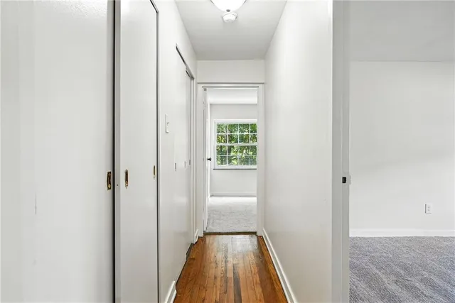 a view of a hallway with wooden floor